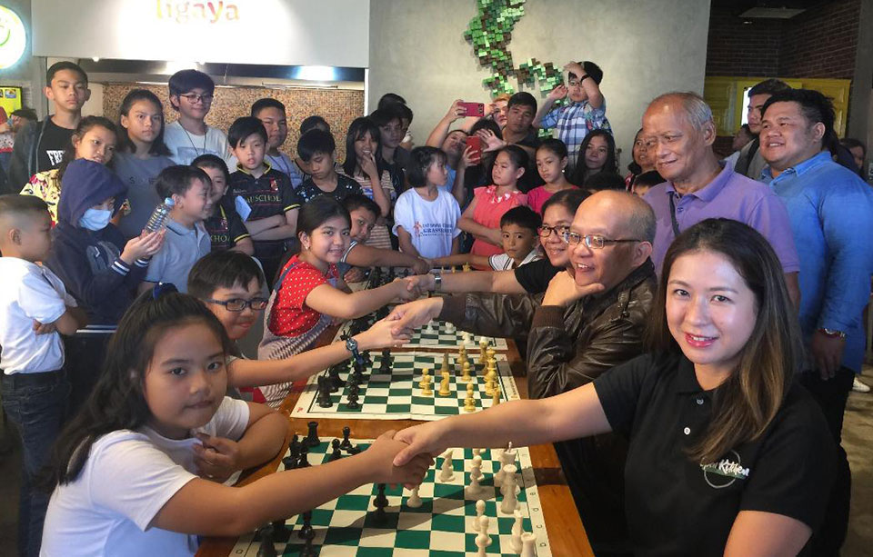 Photo shows Bonjoure Fille Suyamin, Miguel Ebreo and Woman Fide Master Antonella Berthe Racasa made the ceremonial moves against Ms. China Aurelio, International Master Angelo Young and  Ms. Emerita "Mimi" Casas of Open Kitchen usher the start of the Open Kitchen Kiddies 14 Years old and below Rapid Chess Championship held at the  Open Kitchen, Rockwell Business Center-Sheridan, Highwayhills, Mandaluyong City on Sunday.