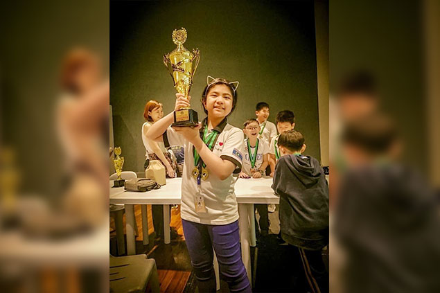 THE Philippines' youngest Woman Fide Master Antonella Berthe "Tonelle" Murillo Racasa display her individual championships' trophy after winning the fifth International School Manila Chess Cup last Saturday at the International School Manila in Taguig City. The top player of the Home School Global chess team are looking for another coveted title when she join in the upcoming Asian Youth Chess Championships slated from April 1 to 10, 2019 in Kaluthara, Sri Lanka.