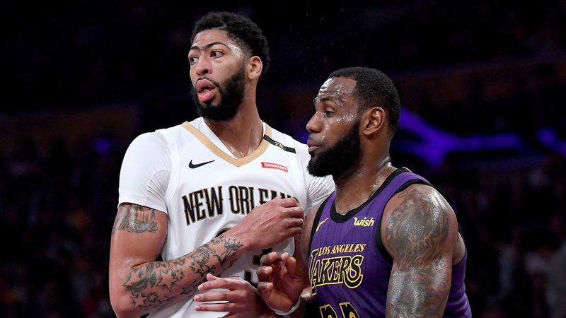 Lakers star LeBron James, right, guards New Orleans Pelicans forward Anthony Davis during a game in December. The Lakers' decision to acquire Davis vaults them to among the NBA's elite teams. (Harry How / TNS)