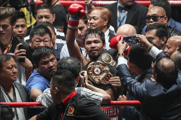 Manny Pacquiao celebrates after defeating Adrien Broner in a WBA welterweight title fight  