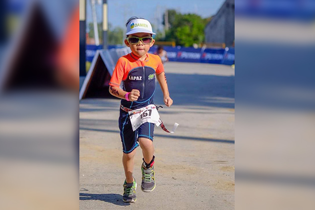 Six-year-old Damien Palo Lapaz jogs to the finish line as he completes the run part of his event. Karen Padawag